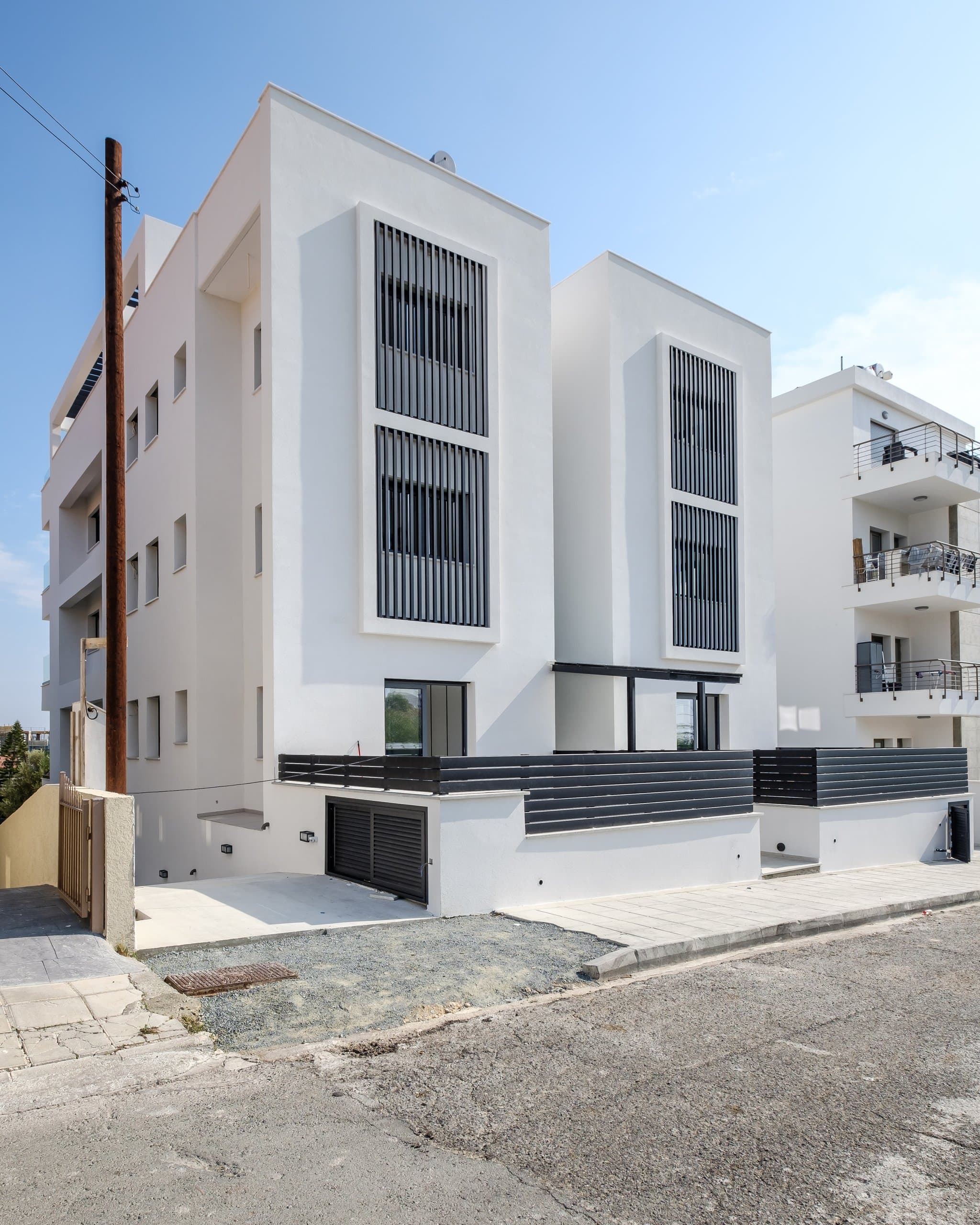 The facade of the completed Simplicity 1 residence in Germasogeia, portrait view